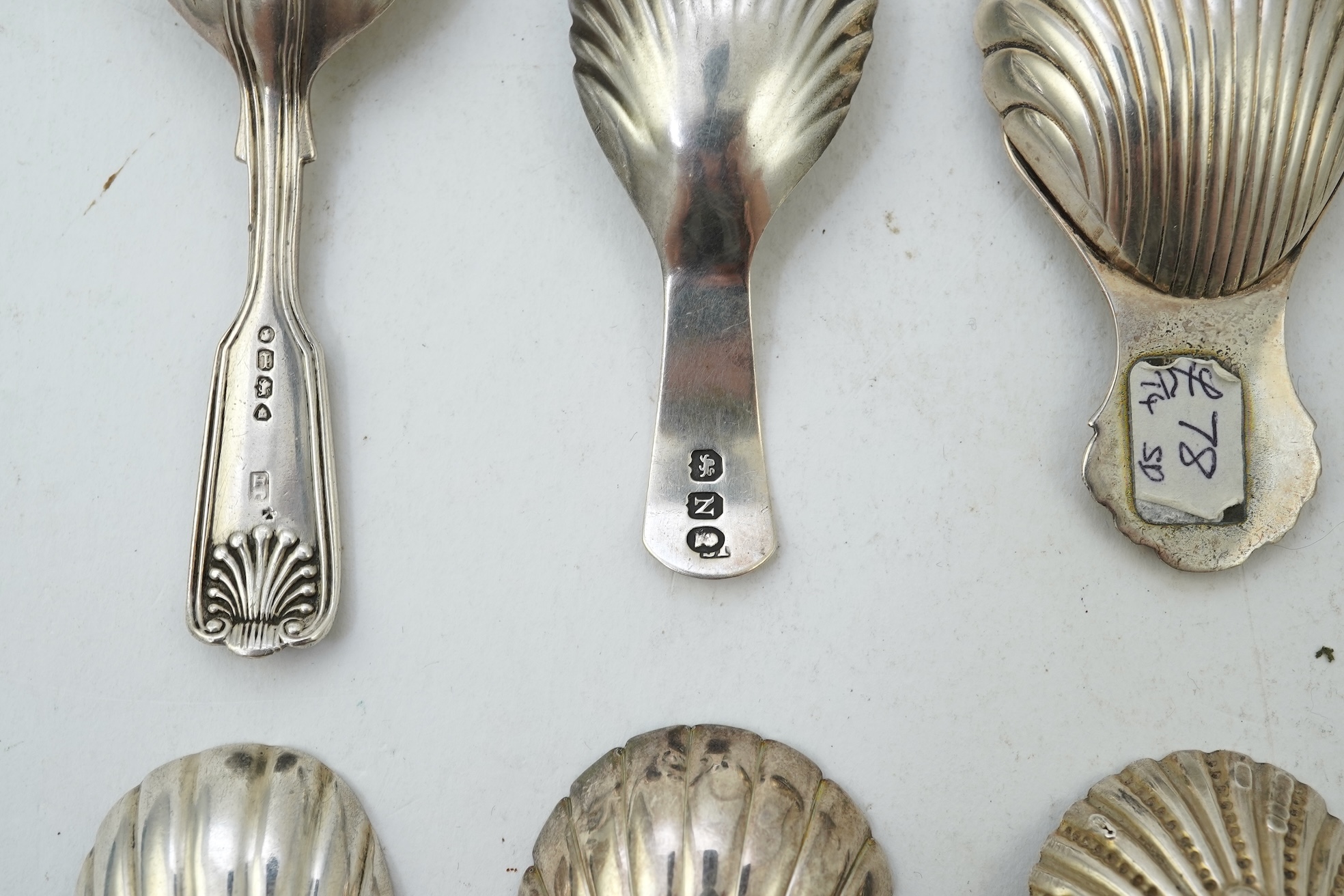 Ten assorted 19th and 20th century silver caddy spoons, with shell or fluted bowls